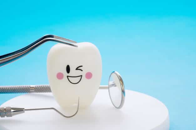 dental-tools-smile-teeth-model-blue-background