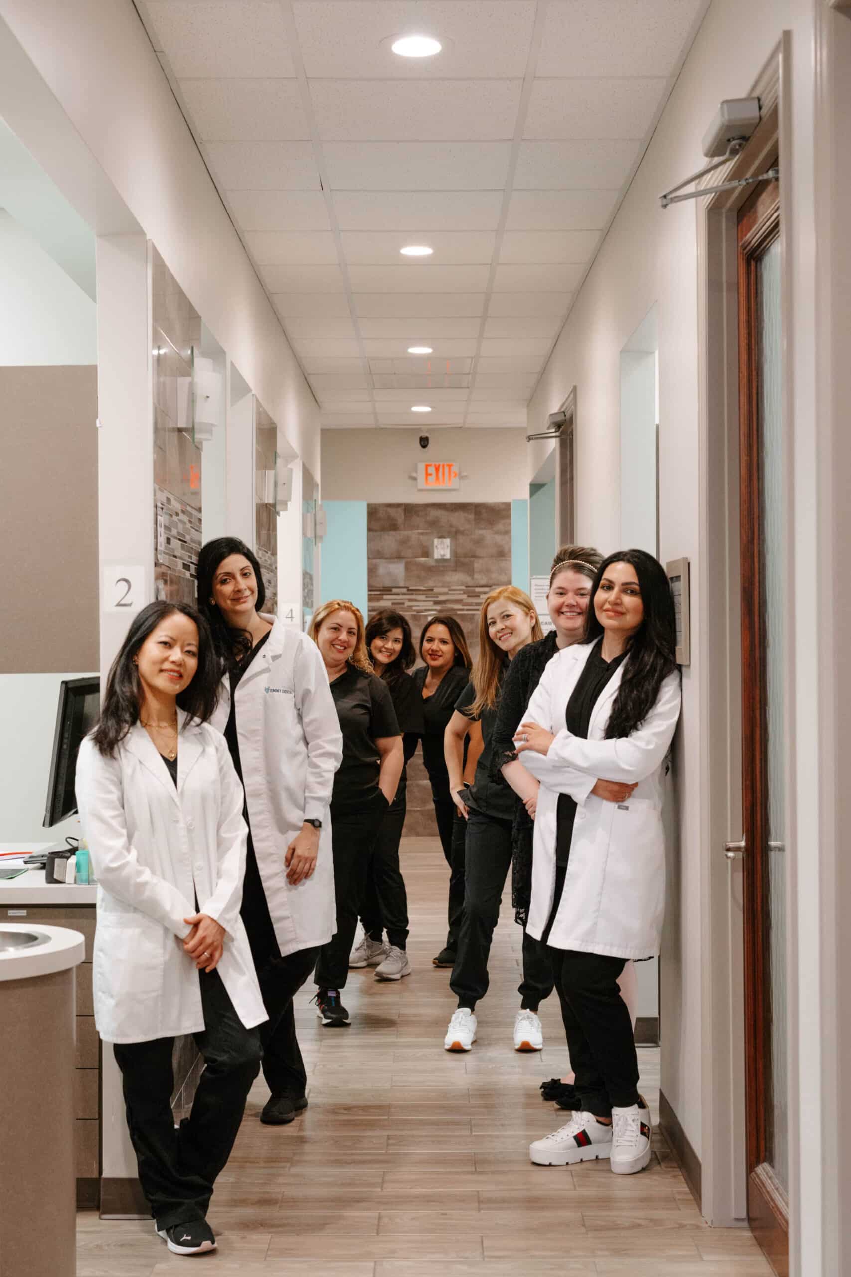 dr pham and team standing together at Emmy dental office 